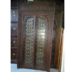 Old doors decorated with brass in...